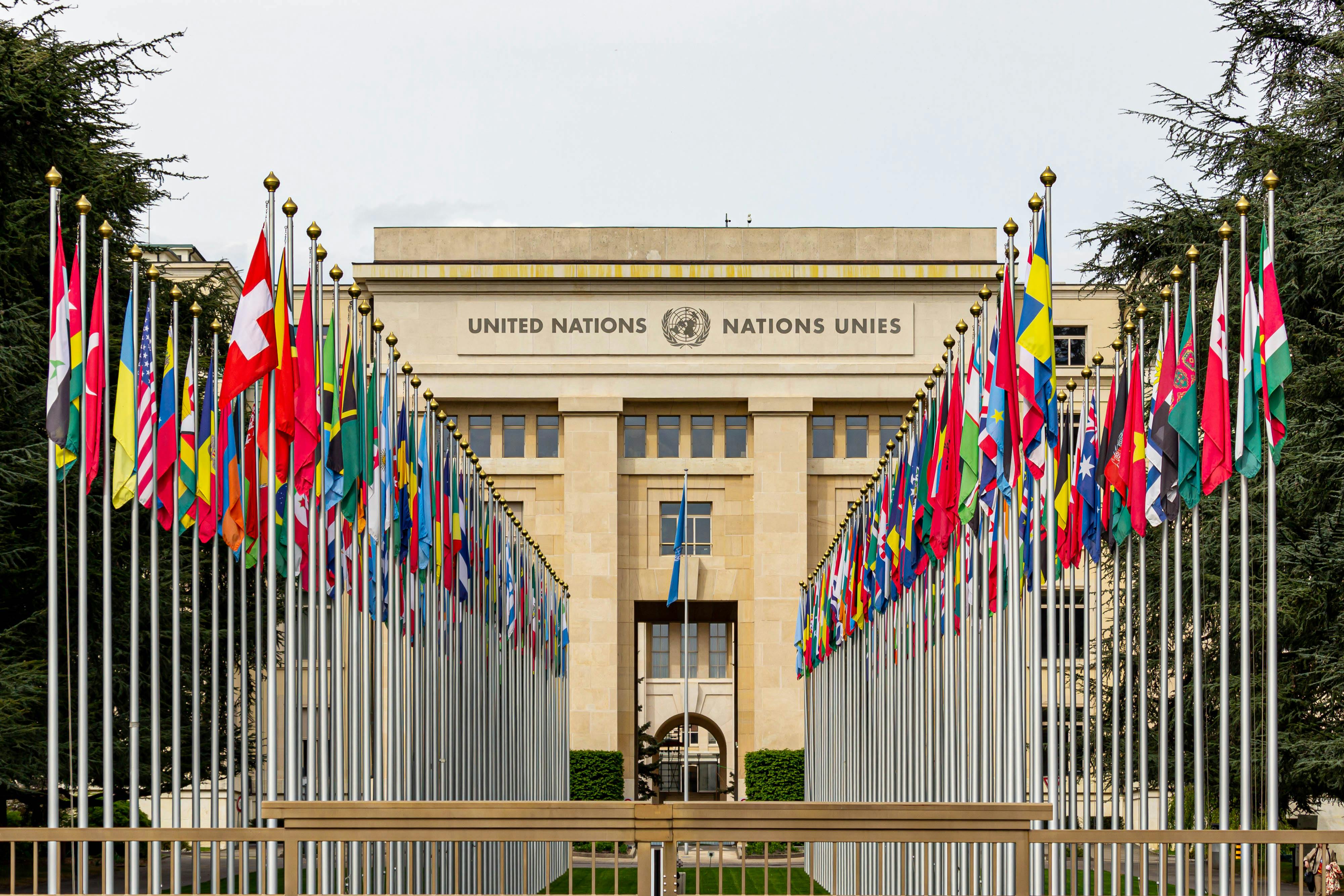 United Nations Office at Geneva with flags of member nations representing international diplomacy